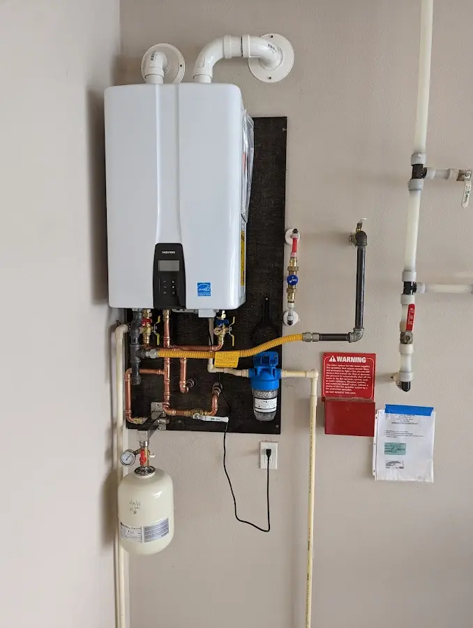 Professional plumber installing copper piping in a Nottingham home